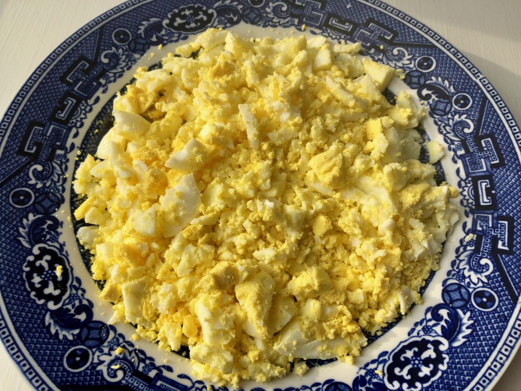 mash hard-boiled eggs with a fork