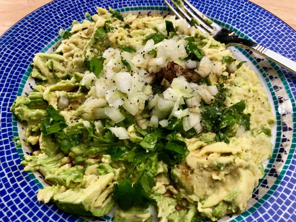 mix ingredients, spices and sauces into the smashed avocado