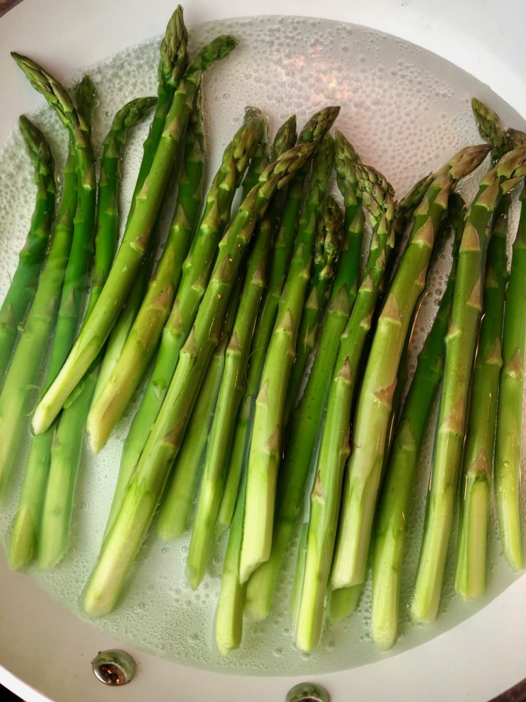 place asparagus in a pan with some water and cook asparagus for 5 minutes