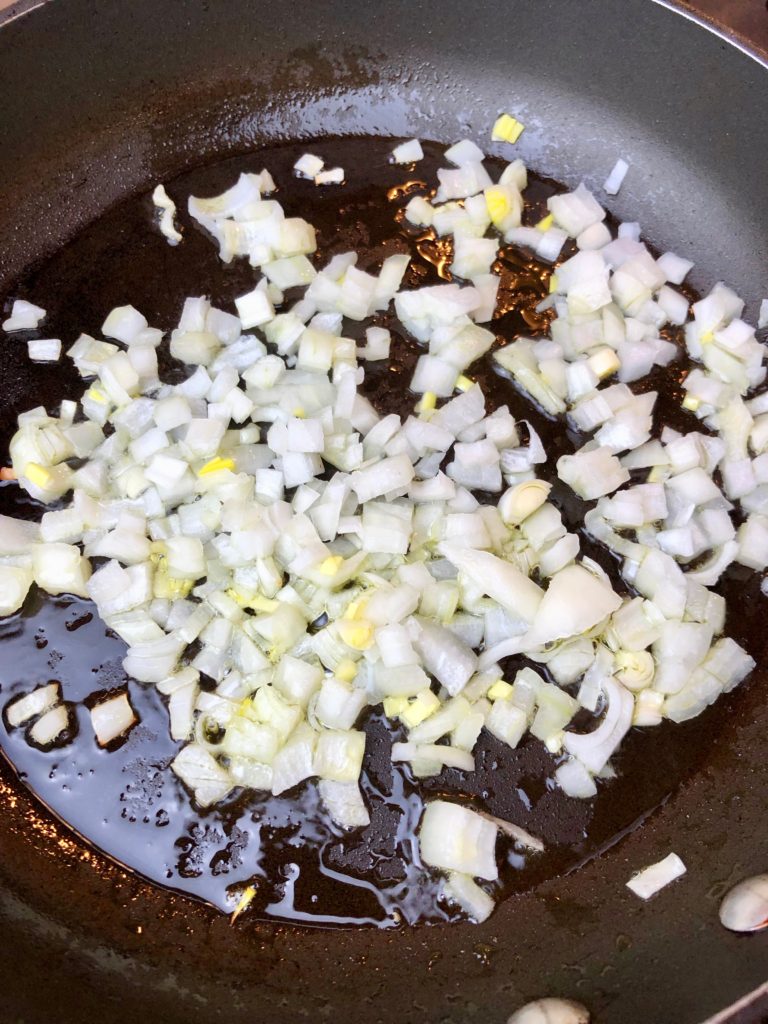 place diced raw onion in the pan