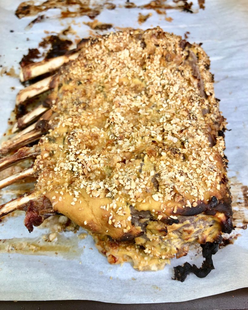 cooked rack of lamb before it's sliced into chops