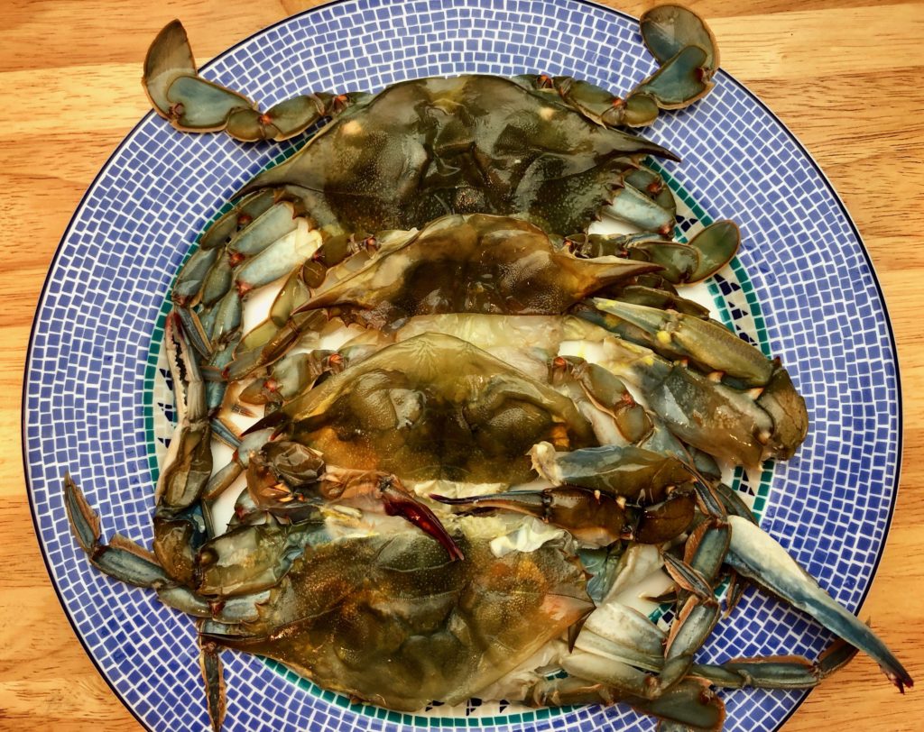 uncooked soft shell crabs that have been cleaned by the fish monger