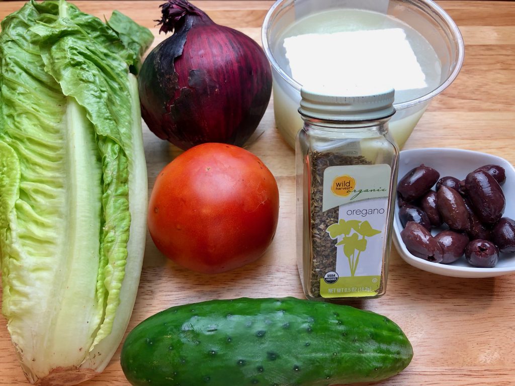 greek salad ingredients...romaine, tomato, onion, cucumber, feta, kalamata and oregano