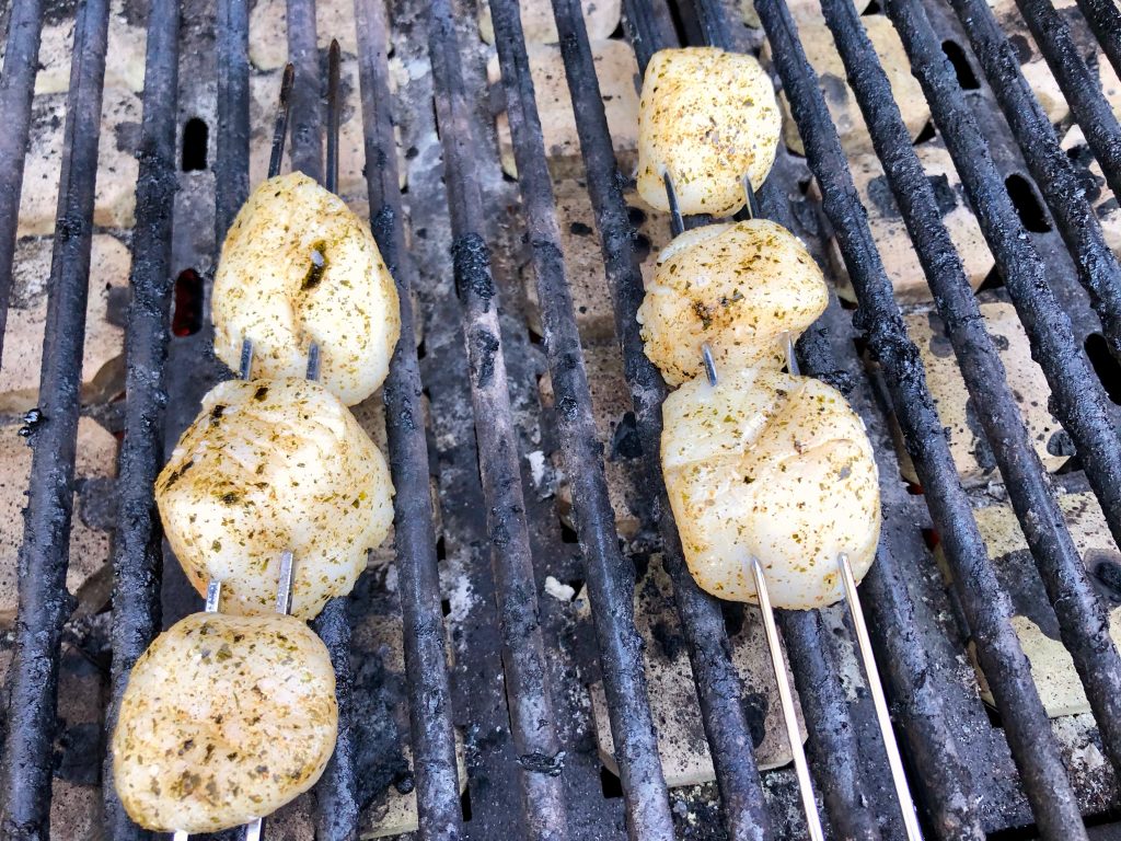 grilling first side of scallops coated with nori, ginger, coriander and oil