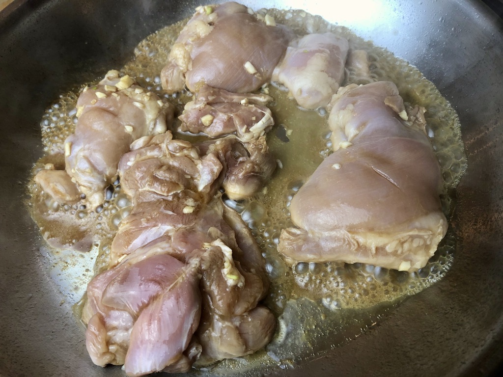 removing chicken thighs from marinade and cook in a large pan
