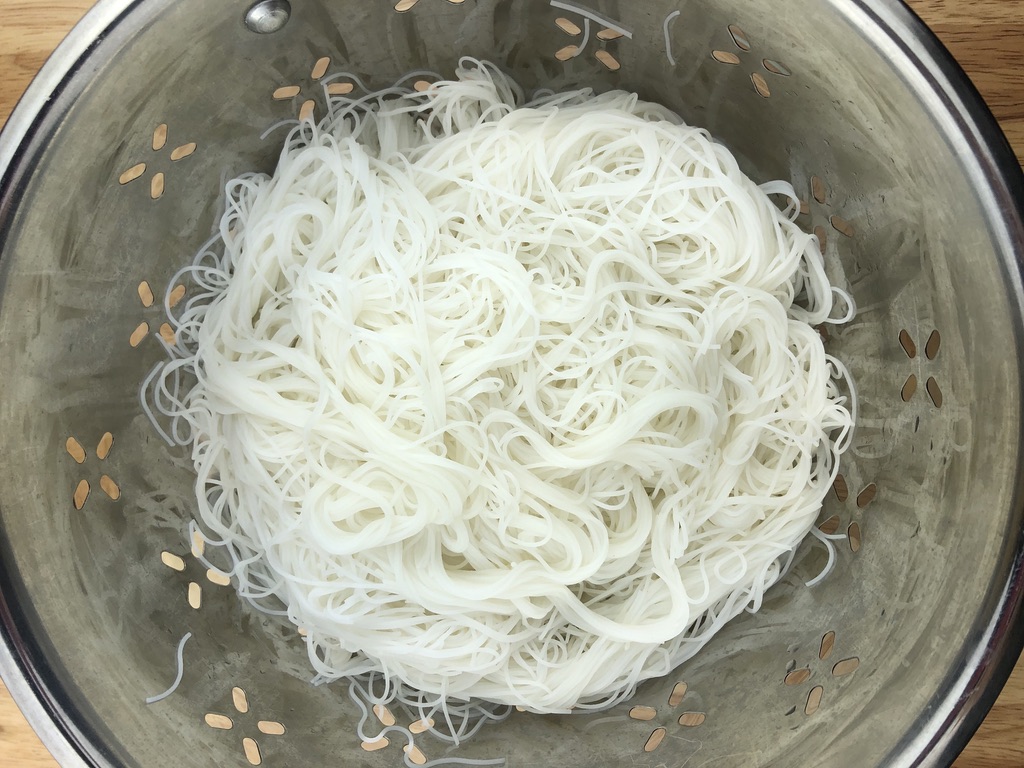 Cooked and strained rice vermicelli noodles