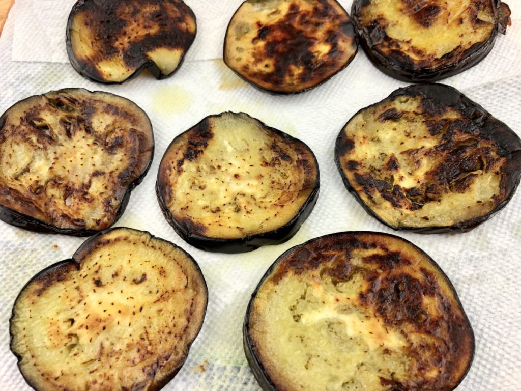 eggplant slices on paper towels to soak up excess oil