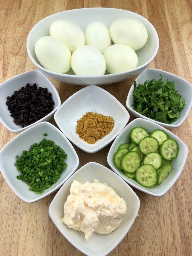curried egg salad ingredients;  hard boiled eggs, mayo, curry, currants, chives, cilantro and cucs