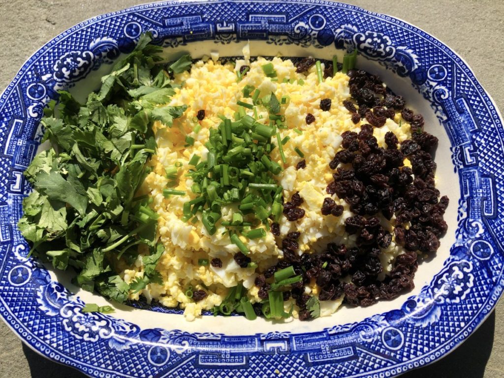 chopped eggs with cilantro, chives and currants