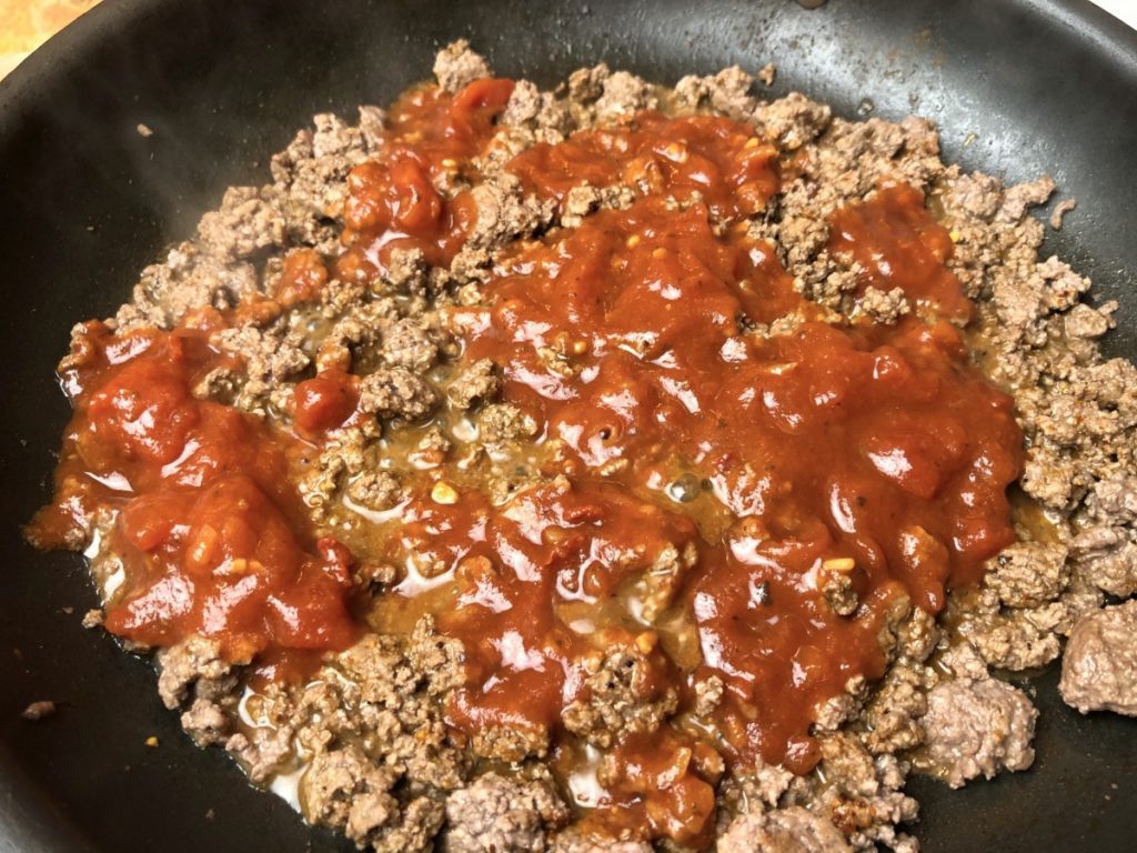 tomato sauce added to taco seasoning and beef
