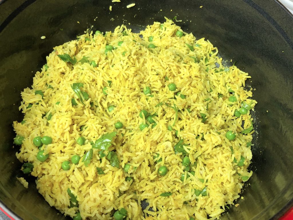 peas and parsley mixed into the rice