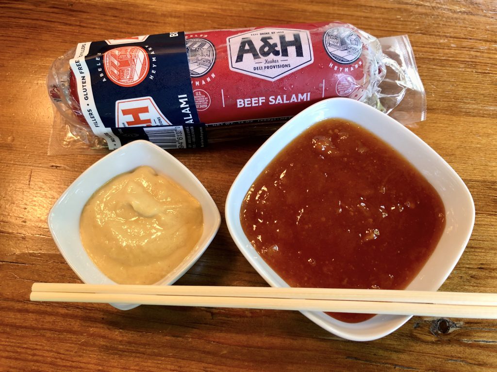 salami log, sauce, mustard and chopsticks