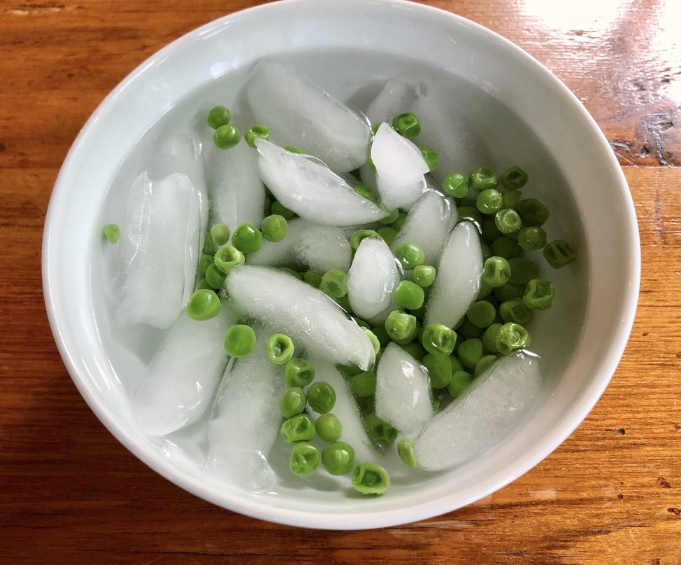 shocking cooked peas in ice water to retain bright green color