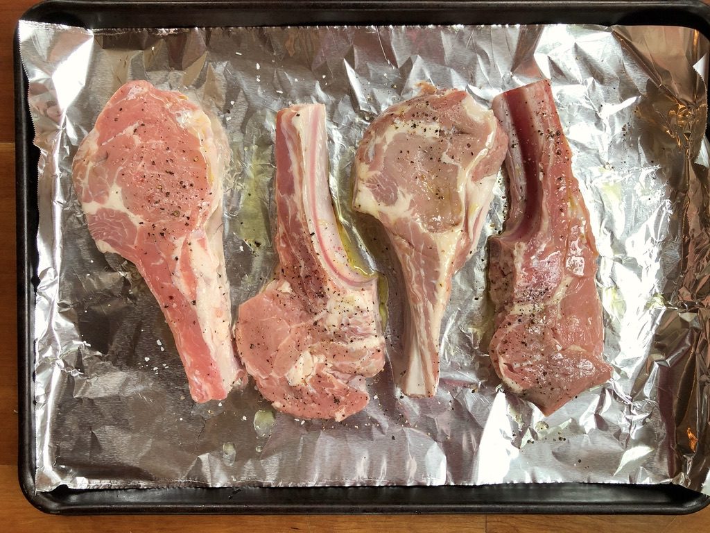 veal chops with seasoned with olive oil, kosher salt and pepper
