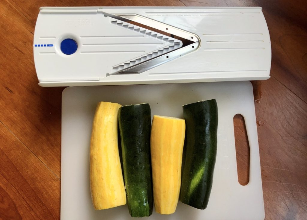 squash and zucchini with ends trimmed and a mandoline