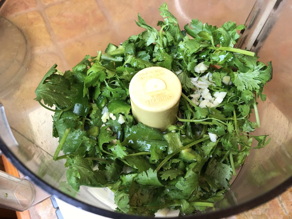 cilantro and seasonings in the food processor