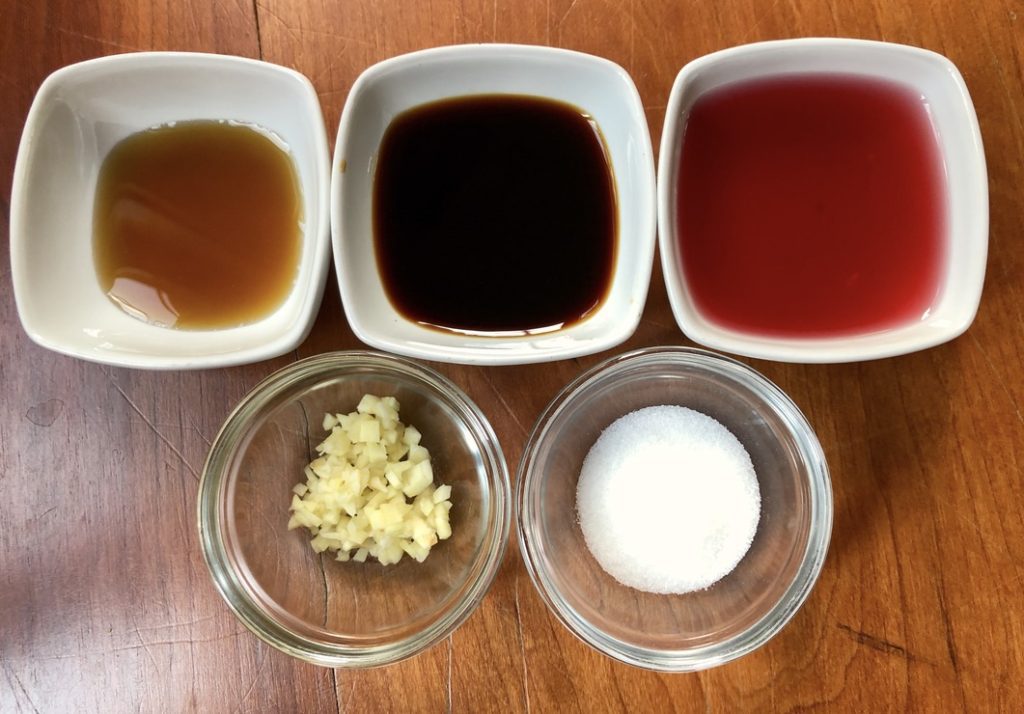 ingredients for sauce - red wine vinegar, minced garlic, gluten free soy sauce, fish sauce and sugar