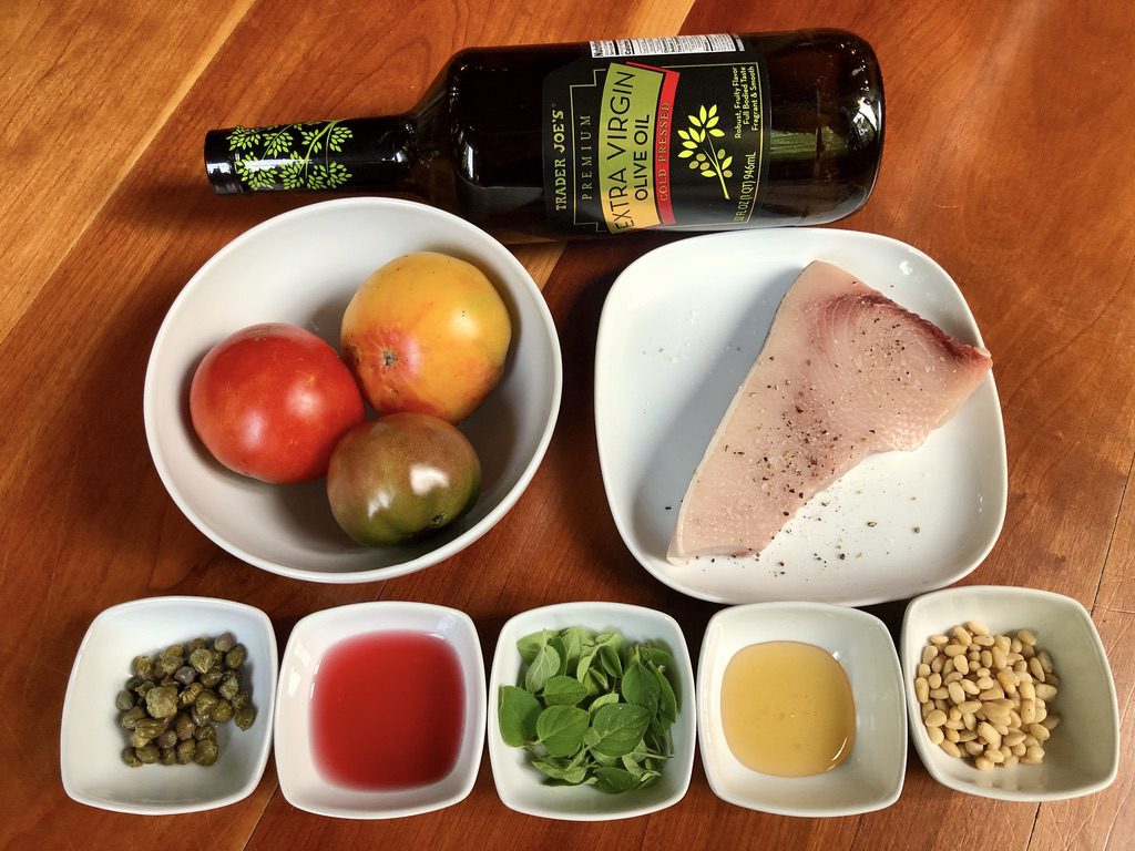 ingredients for grilled swordfish and sliced tomatoes with Oregano/Caper Dressing; swordfish steak, tomatoes, capers, oregano, honey, red wine vinegar, olive oil, and pine nuts