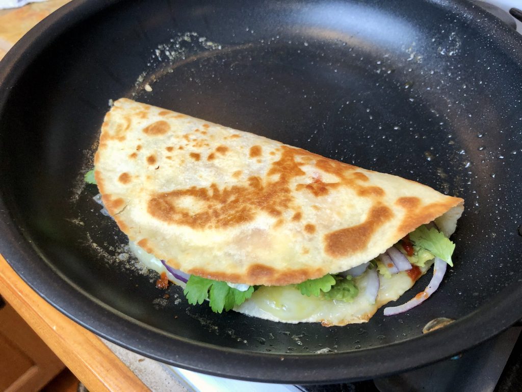 fold over quesadilla and transfer to a plate