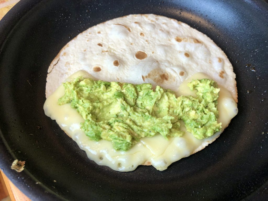 spoon the smashed avocado on top of the melted cheese