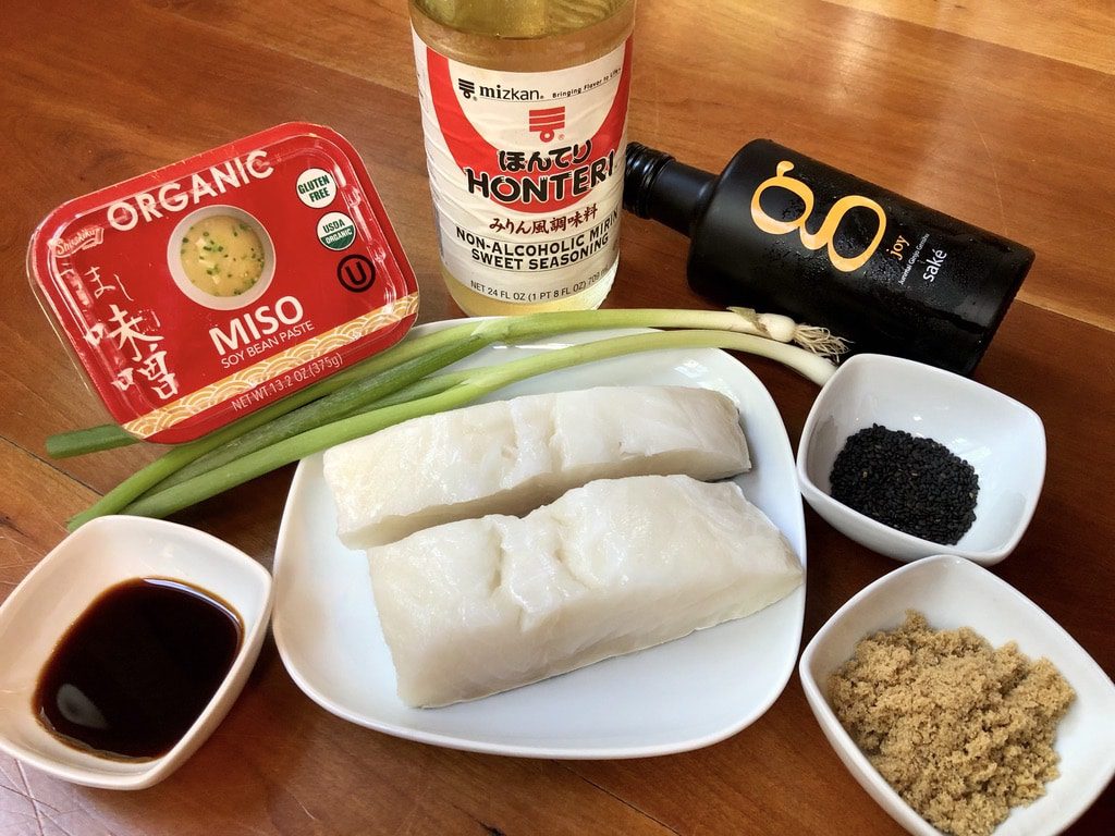ingredients for miso-glazed chilean sea bass: sake, mirin, miso, gf soy, brown sugar, chilean sea bass fillets, scallions, and black sesame seeds
