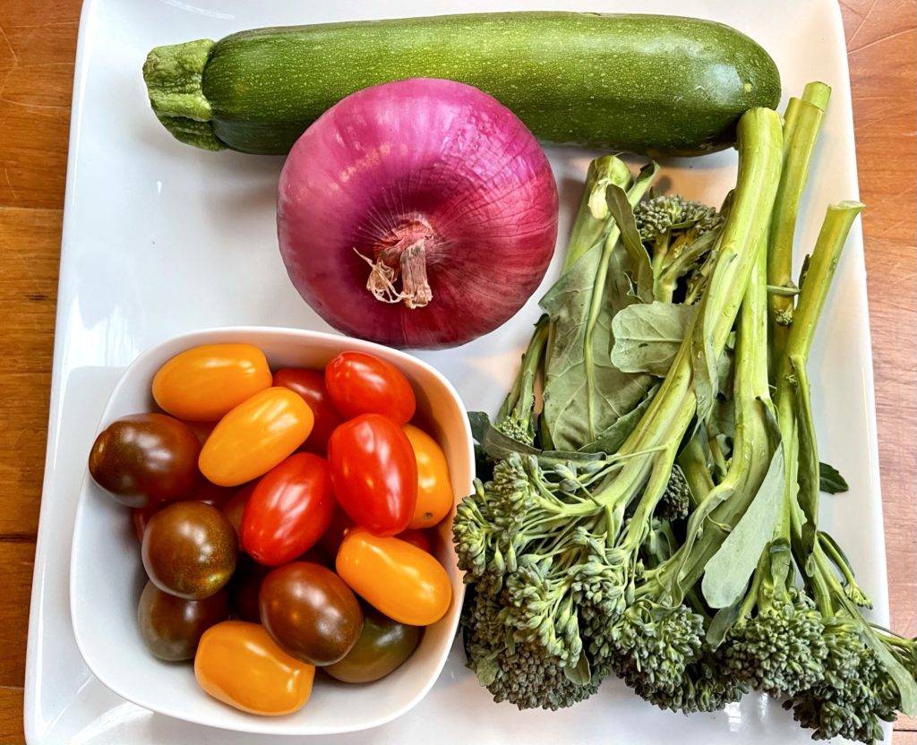 zucchini, grape or cherry tomatoes, broccolini, and red onion