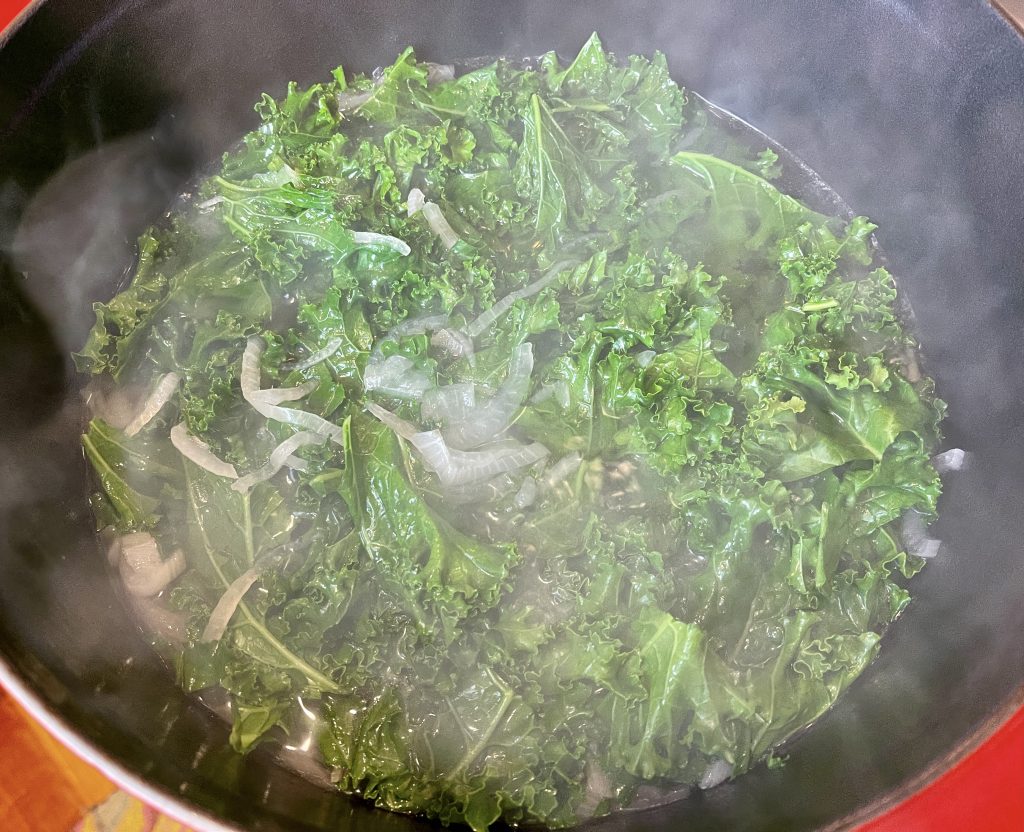 adding the greens to the broth