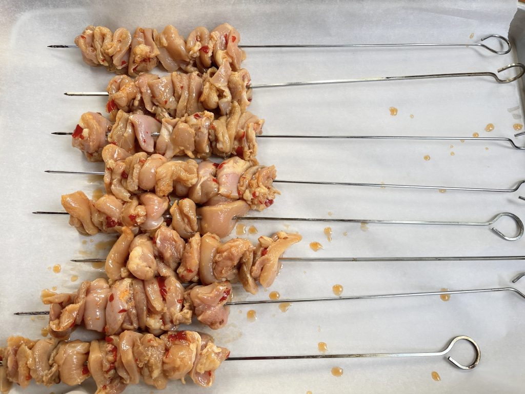 Remove chicken and thread 6-8 pieces on each skewer