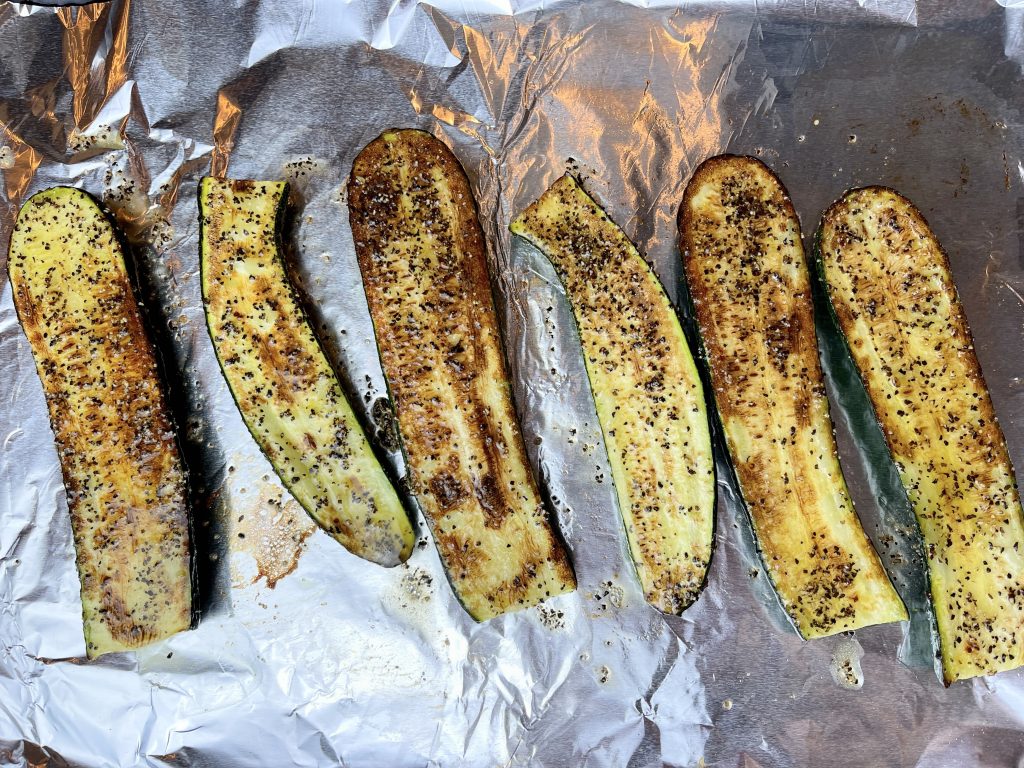 brush black pepper butter on the zucchini halves