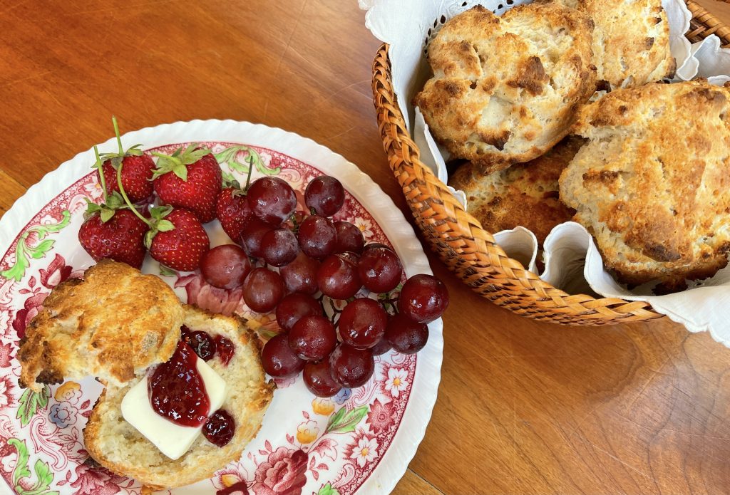 light and fluffy gluten free biscuits with butter and jam served with fresh fruit