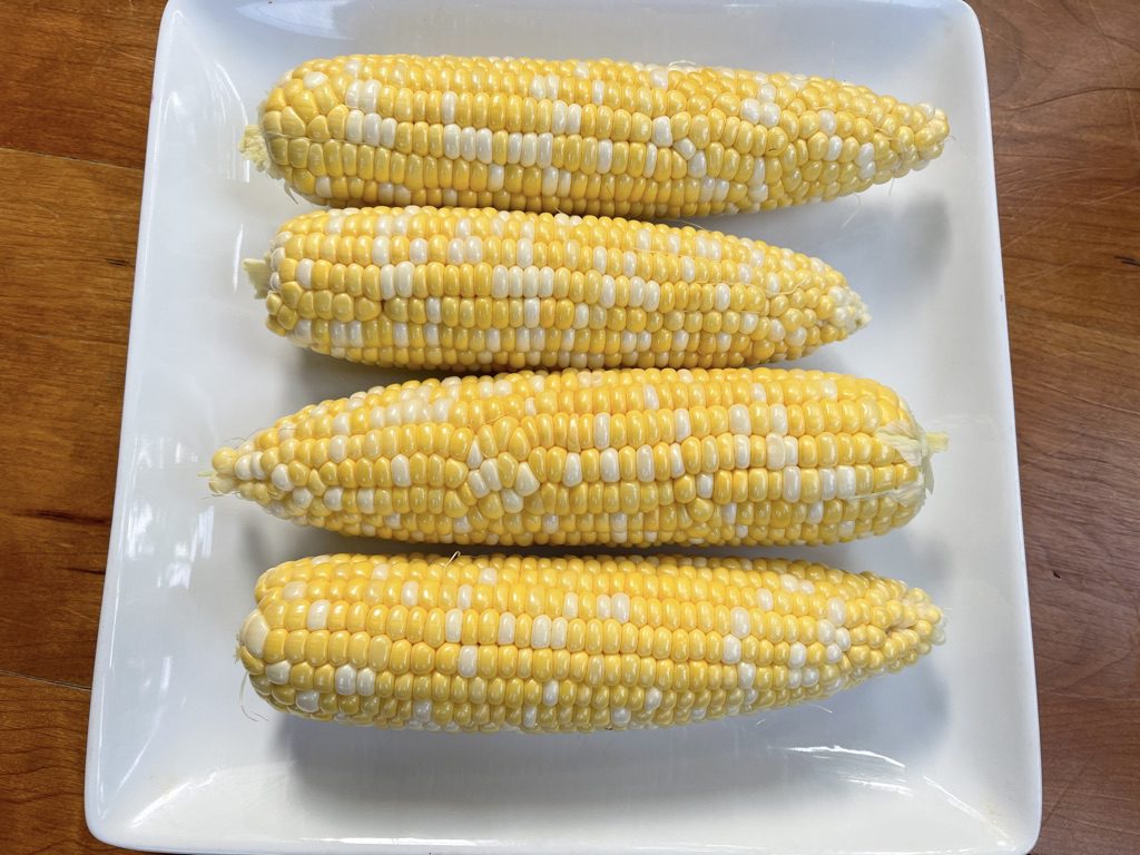 husks removed from fresh ears of corn