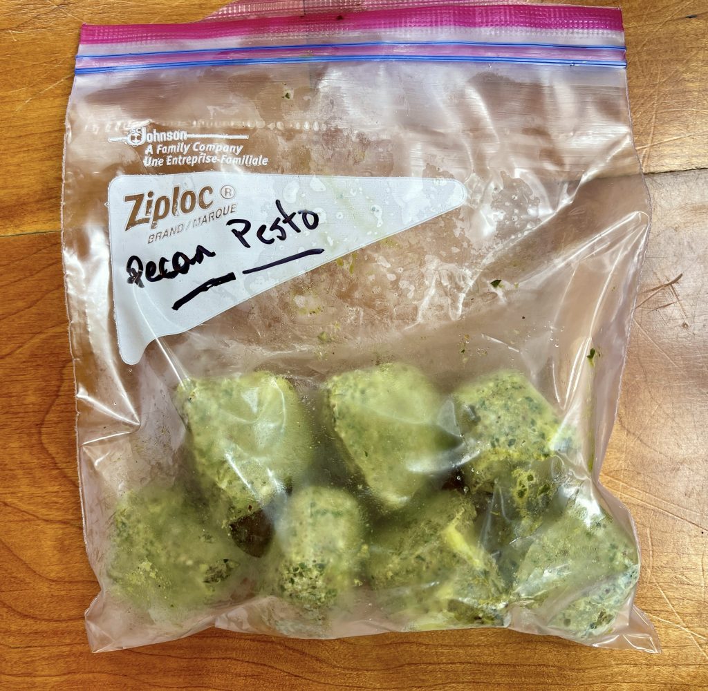 once pesto is frozen, pop out the individual cubes and place in a sealed freezer baggie and freeze for later use