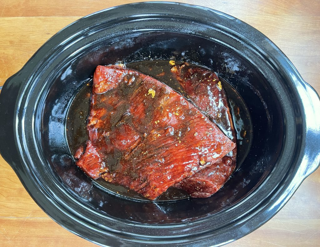 Place brisket in the slow-cooker and pour the sauce on top