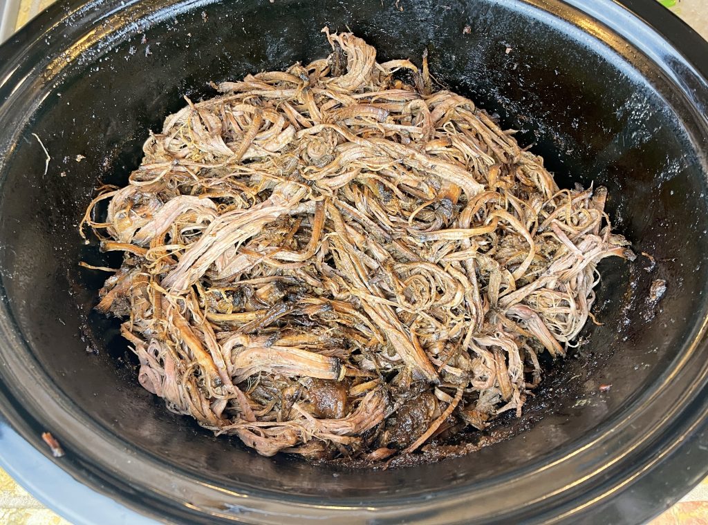 while the sauce is reducing, shred the brisket with two forks