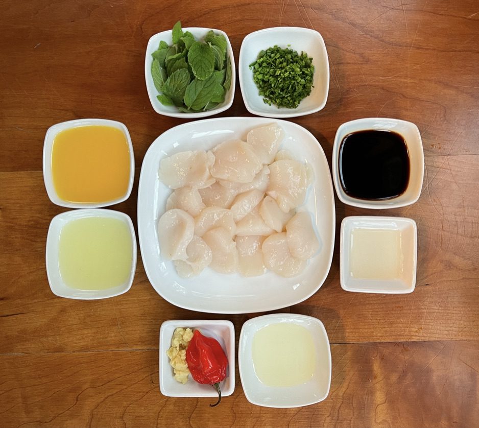 scallop crudo ingredients:  fresh orange juice, lemon juice, gluten free soy sauce, neutral oil, grated ginger, vinegar, sea scallops, red chile, mint leaves, chives, and salt 