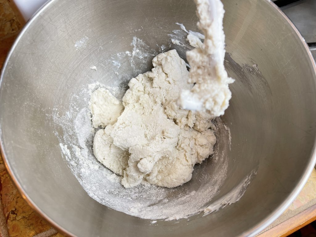 Place flour, salt, baking powder, and yogurt in the mixer with the egg white and gently mix ingredients together with a rubber spatula and then using the dough paddle attachment mix the dough together