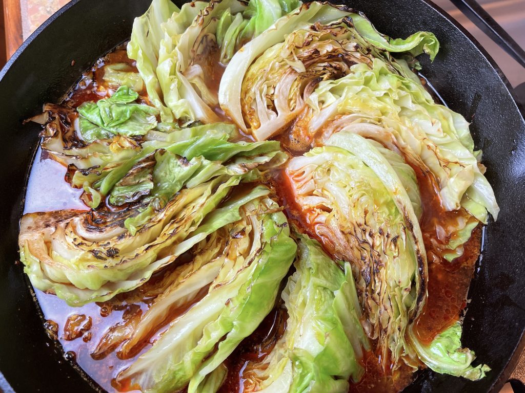 place all cabbage wedges back into the pan (they should all fit now)