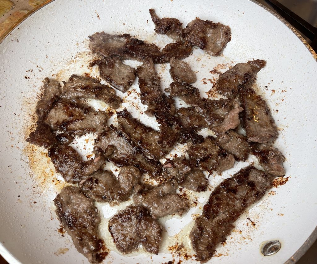 turn steak strips over using tongs and cook other side until browned and crispy
