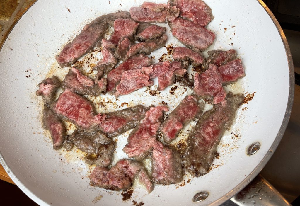 cook steak in batches over high heat until browned and crispy on  bottom side
