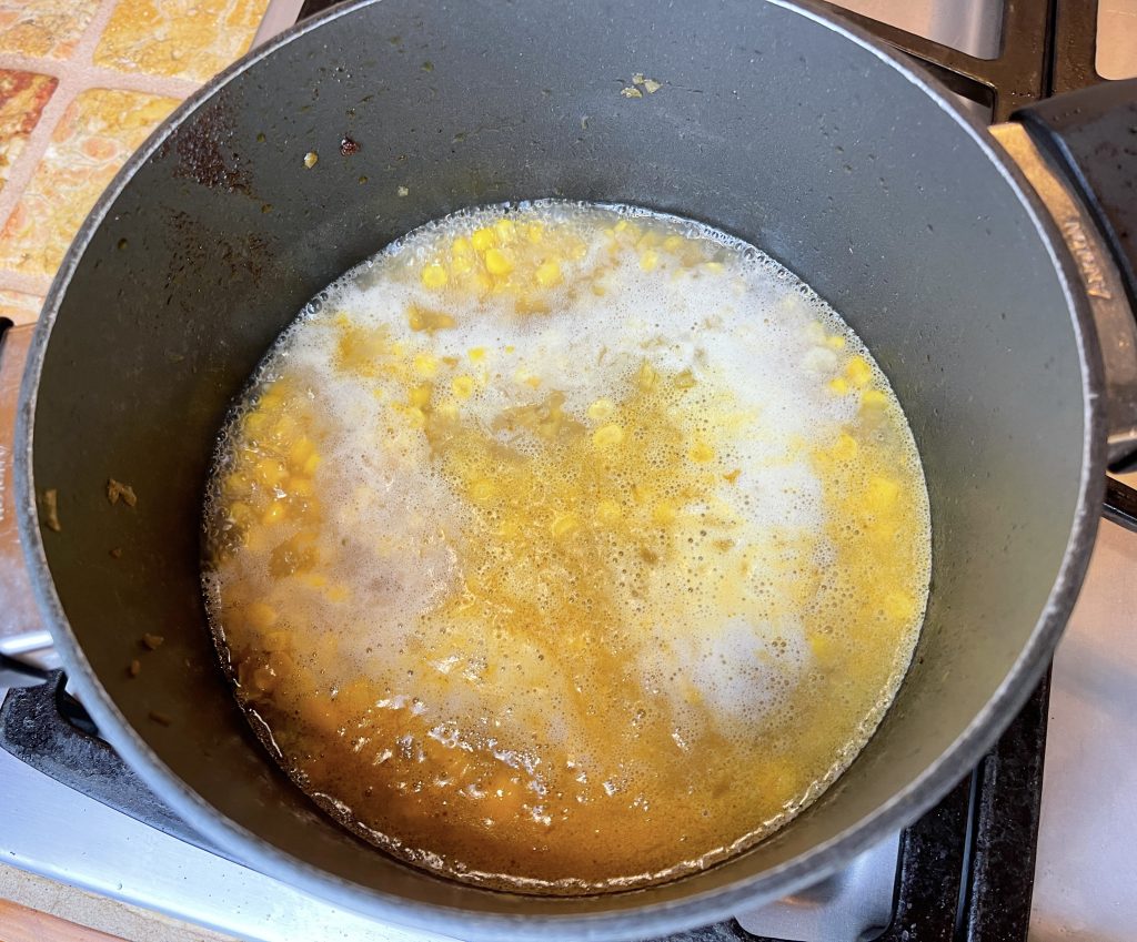 add water to the remaining broth in the pot. bring to a simmer and add the corn.