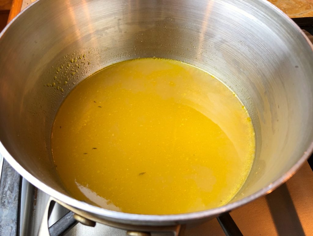 heat strained broth on low