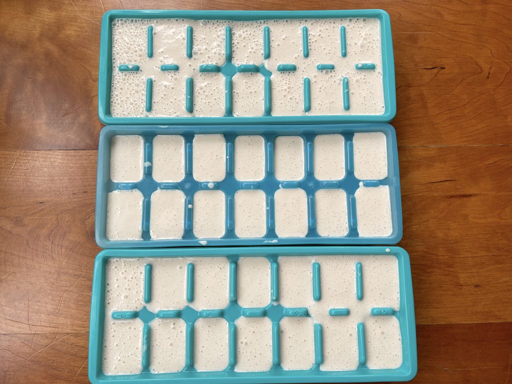 pour tahini blend into three ice cubes trays