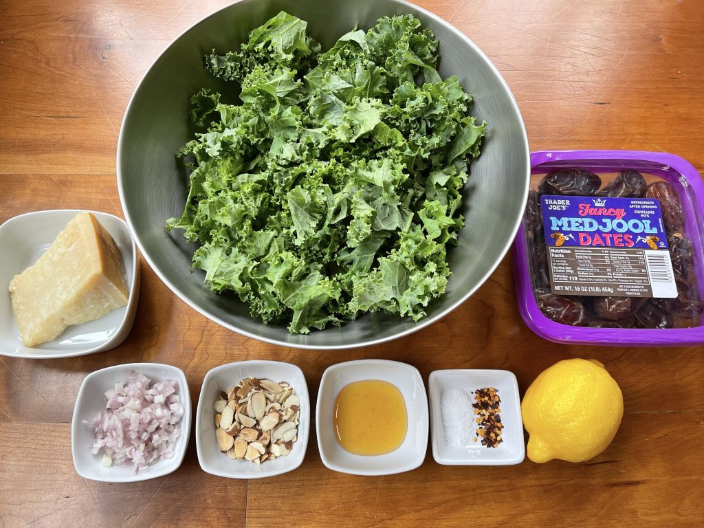 ingredients for kale salad - kale, dates, parmesan, almonds, shallots, honey, lemon, salt, and hot pepper flakes