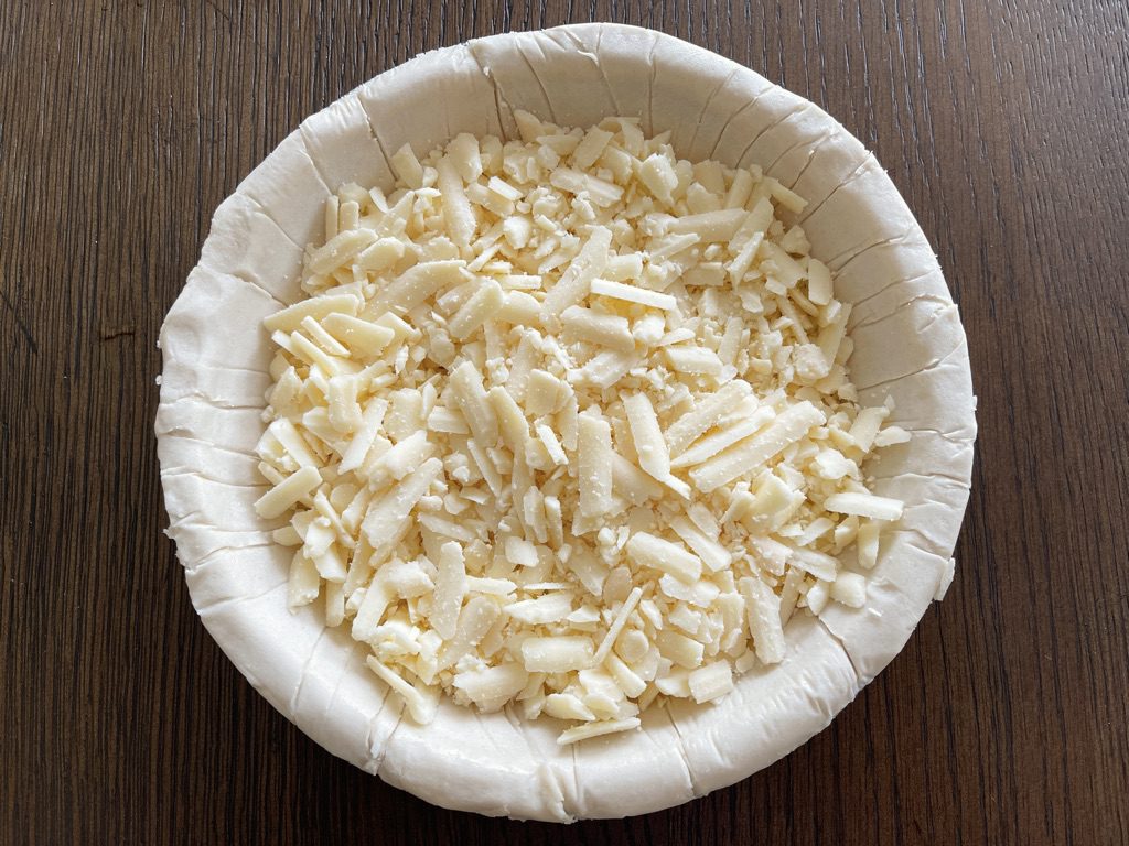 place cheddar cheese in the crust