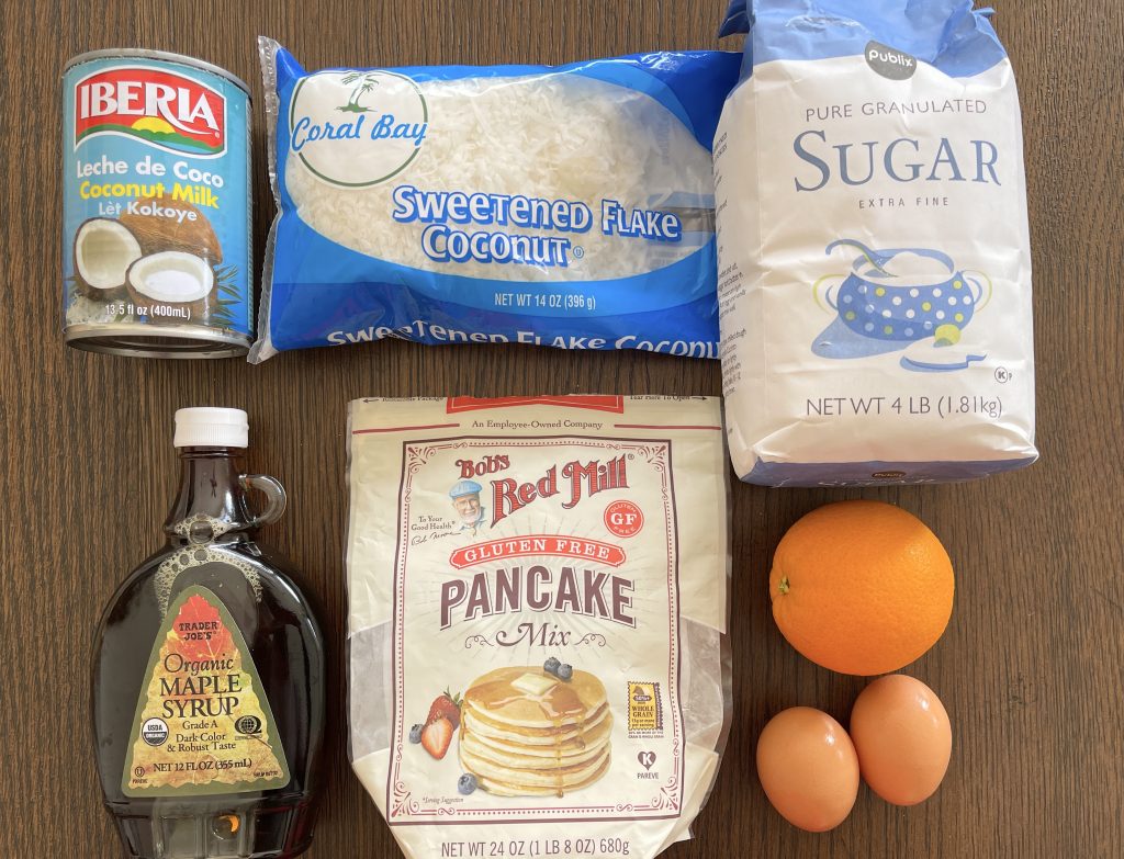 ingredients for orange coconut pancakes - bob's red mill gf pancake mix, eggs, sugar, coconut milk, navel orange, maple syrup and coconut flakes
