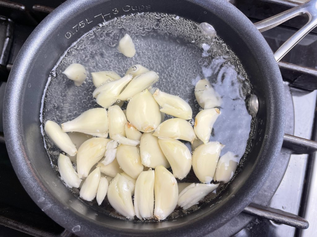 boil garlic cloves for three minutes until tender
