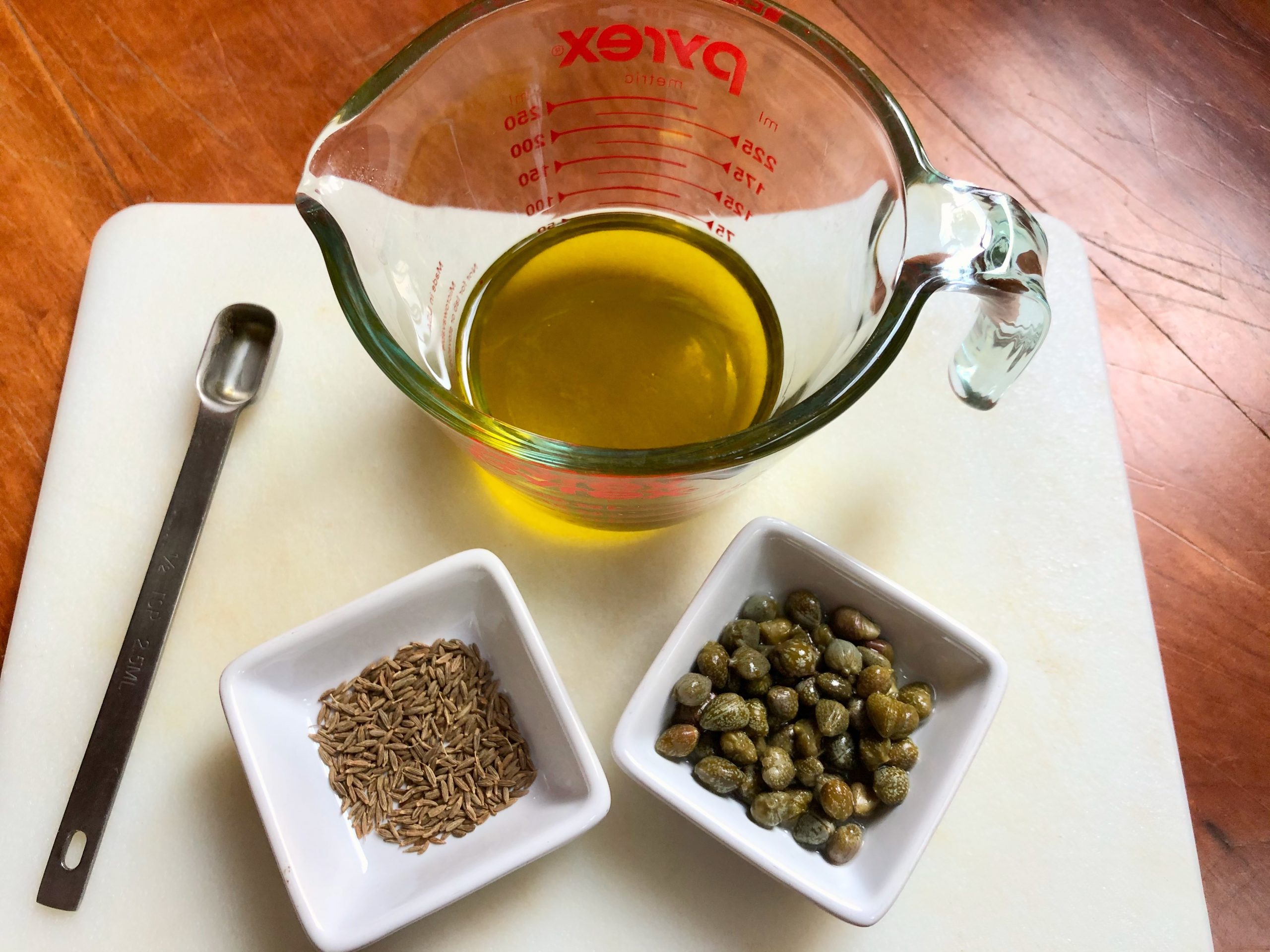 olive oil, cumin seeds, and capers