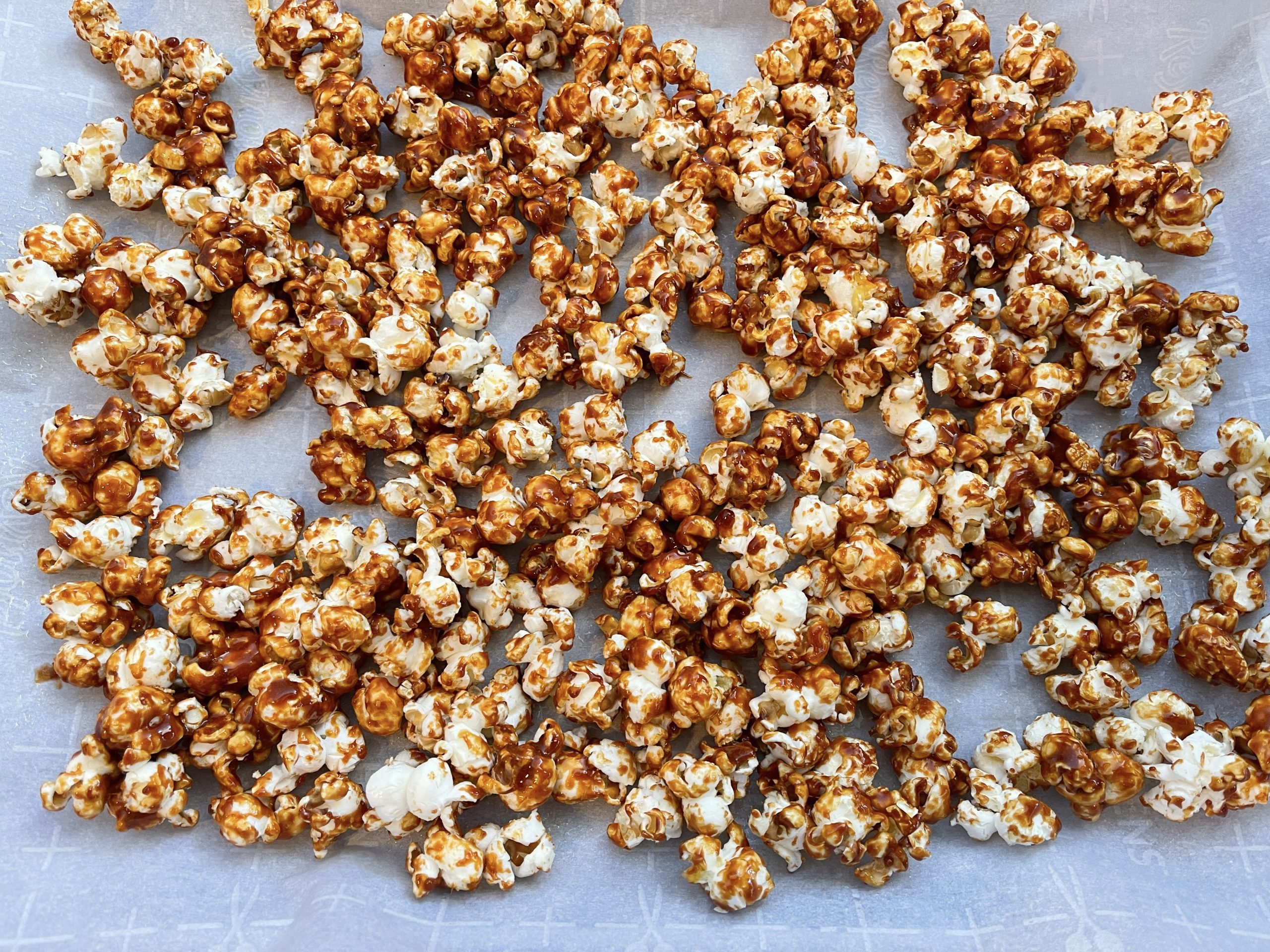 Place popcorn on the parchment-lined baking sheet using a spatula to form a single layer and bake for 15- 20 mins