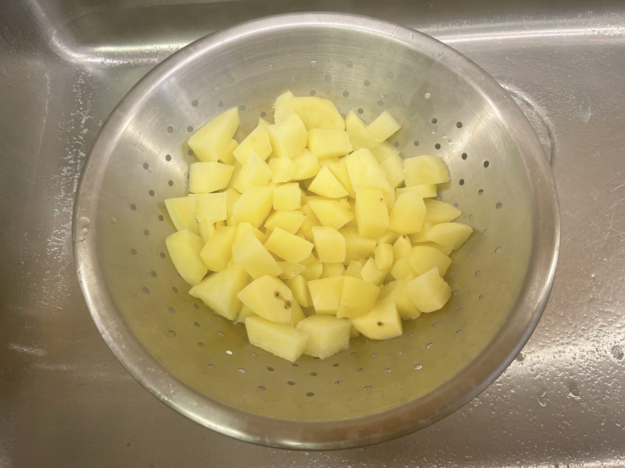 drained cooked potatoes in a colander