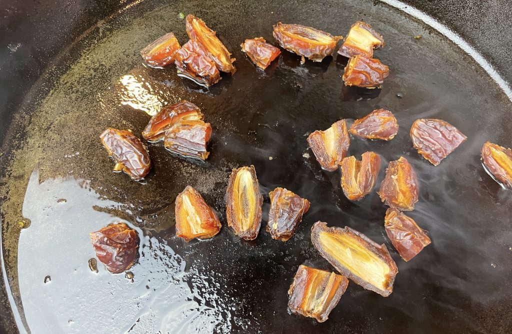 In the same pan, lower heat to medium and add remaining tablespoon of oil. Cook dates, stirring occasionally, until charred in spots and beginning to stick to pan, about 2 minutes.
